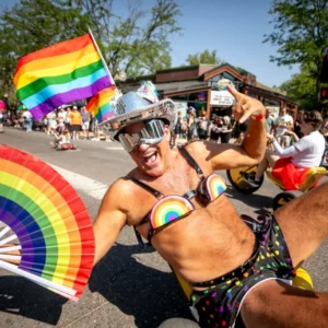 Darren Droge spins around 17th Avenue on a High Roller during Denver's annual Pridefest parade. June 28, 2026. Kevin J. Beaty/Denverite
